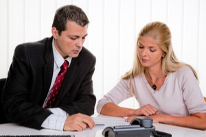 Broker showing insurance plans to a female employer