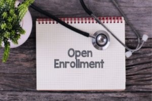 Calendar showing open enrollment schedule while a stethoscope is placed on it