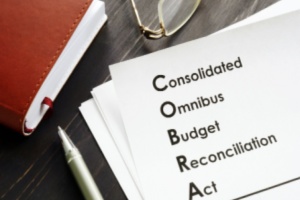 Consolidated omnibus budget reconciliation act COBRA written on a paper