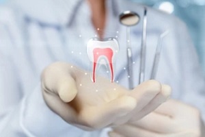 dentist holding dental tools using group dental benefits