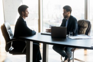eBen agent having a conversation with employer inside an office