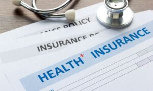 Health insurance related documents and a stethoscope