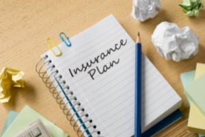 Insurance plan written with pencil on a page of a diary