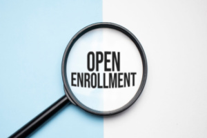 Magnifying glass focusing on open enrollment