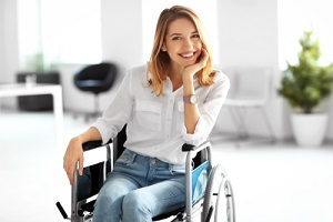 young woman in wheelchair at workplace with long term disability insurance
