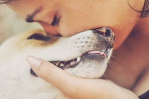 women kissing her dog with pet insurance