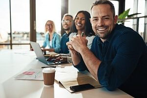 businessman sitting with colleagues in an office