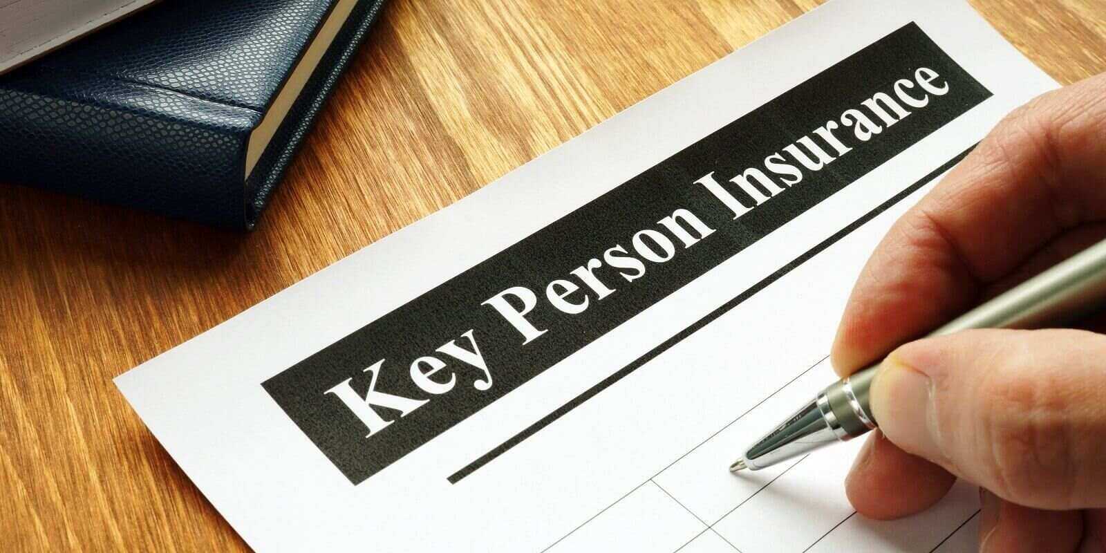 key person Insurance policy agreement on table