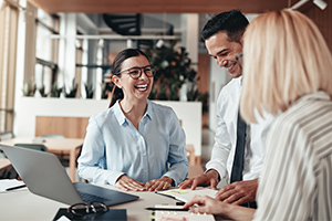 Employees laughing and speaking to each other