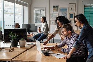 Employees working together in office environment.