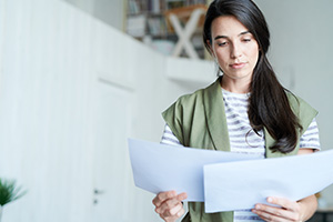 Woman who is reading files in her hand.