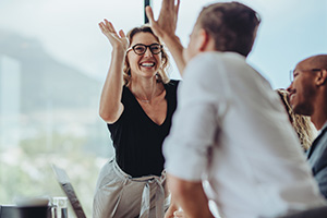 Employees high five each other