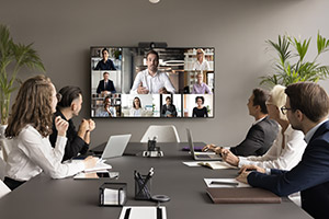 Employees talking to remote workers in conference room