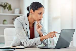 professional woman reading on a computer documentation