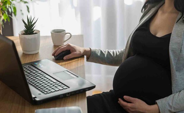 pregnant women working at her desk at work