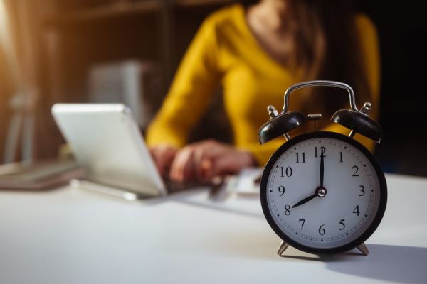 woman next to clock