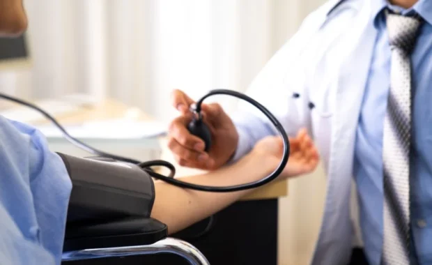 doctor checking blood pressure