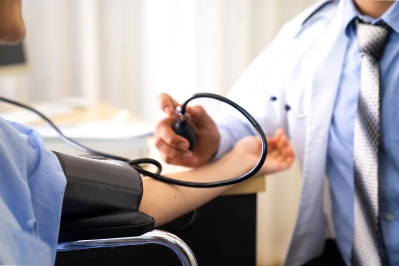 doctor checking blood pressure