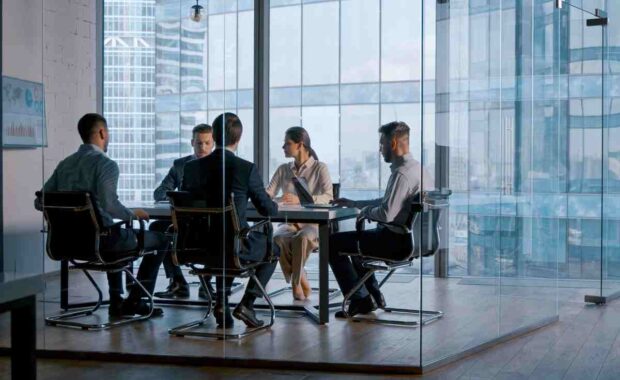 Young business people attending the meeting in boardroom in business district