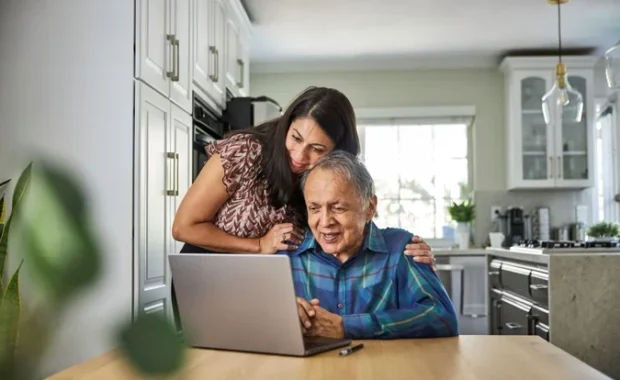 Daughter-with-Older-Parent-at-Home-Laptop-1200-800