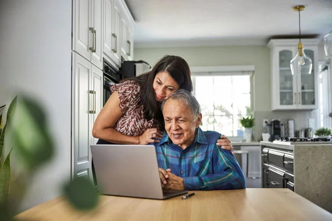 Daughter-with-Older-Parent-at-Home-Laptop-1200-800