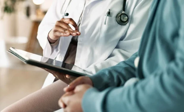 Tablet,-hands-and-patient-with-doctor-in-hospital-for-consultation-with-cold,-flu-and-sickness.