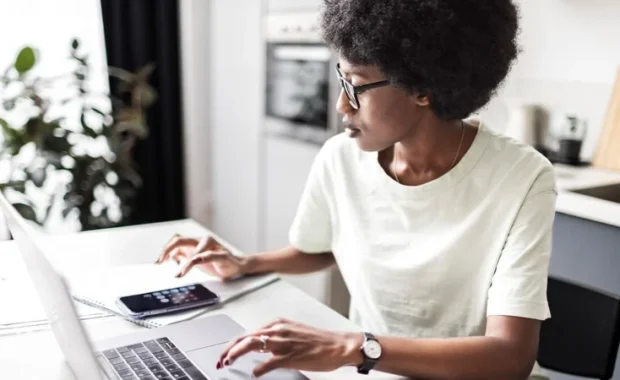 Female-at-Desk-with-Laptop-and-Calculator-1200-680