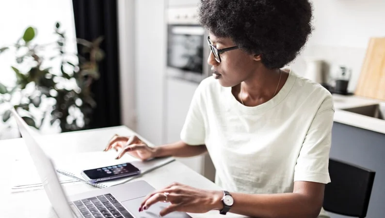 Female-at-Desk-with-Laptop-and-Calculator-1200-680